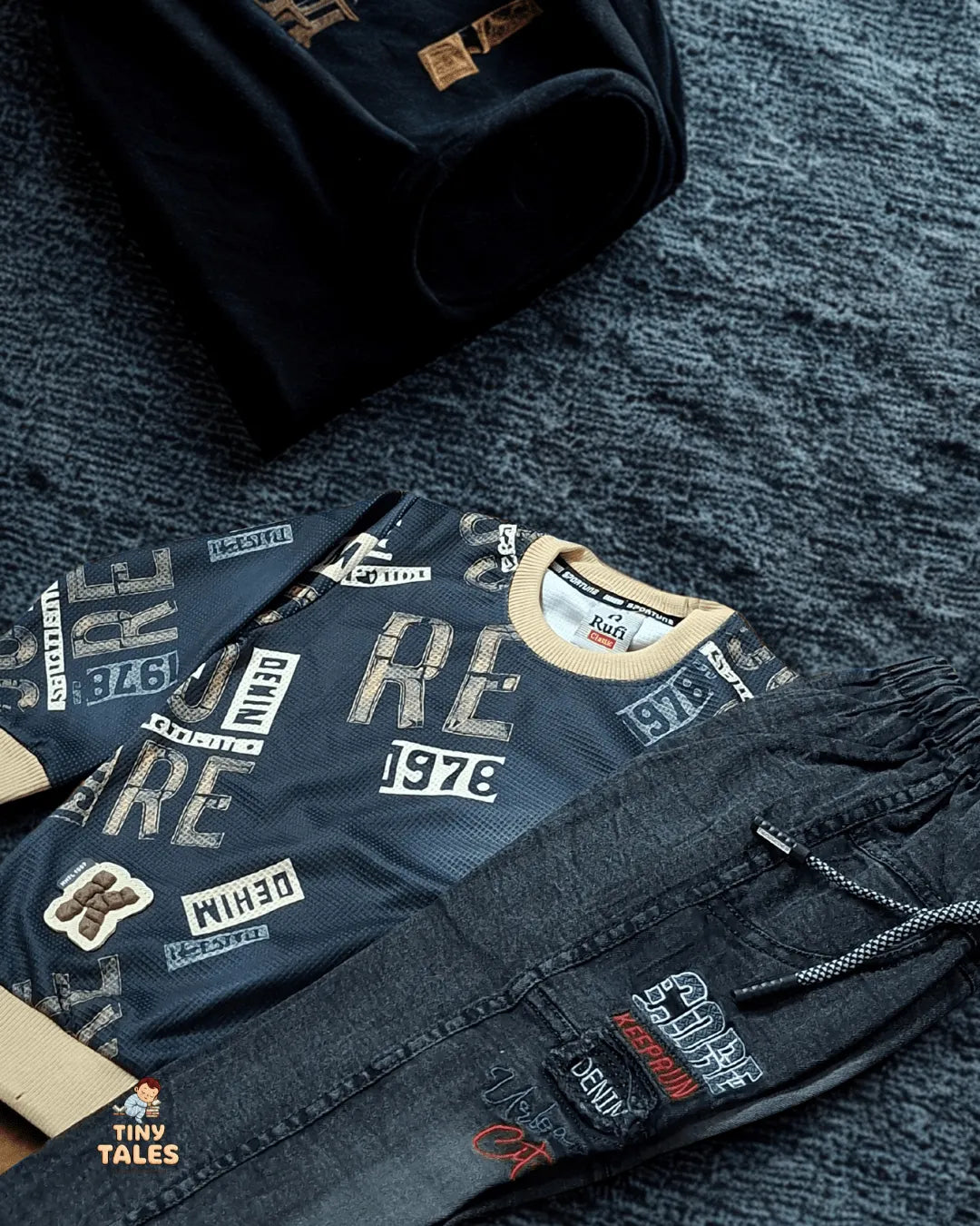 Dark blue denim jacket with various patches on a textured surface