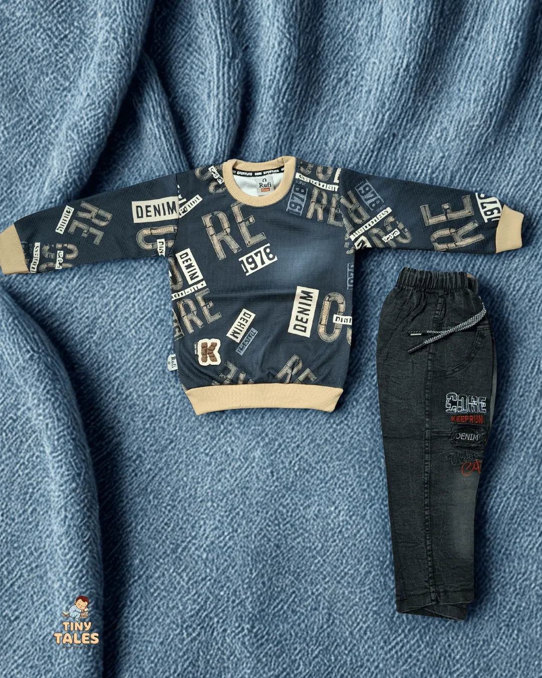 Children's denim sweater and pants set on a textured blue fabric background