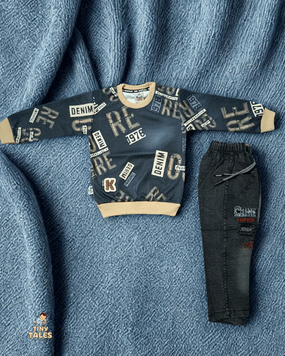 Children's denim sweater and pants set on a textured blue fabric background