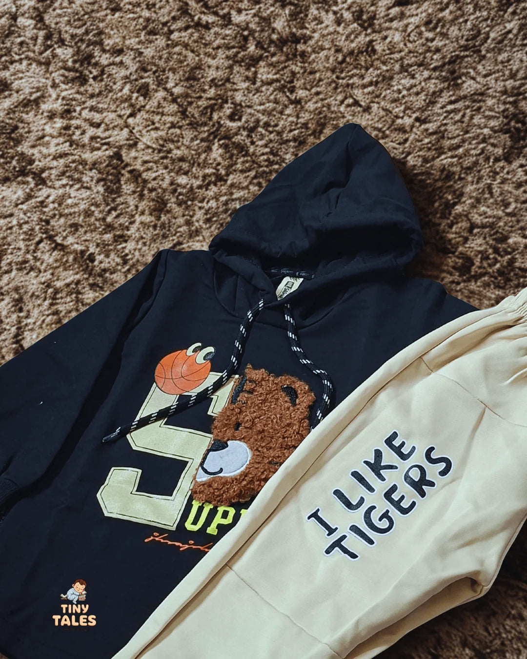 Navy hoodie with cartoon design and 'I Like Tigers' text on a brown carpet
