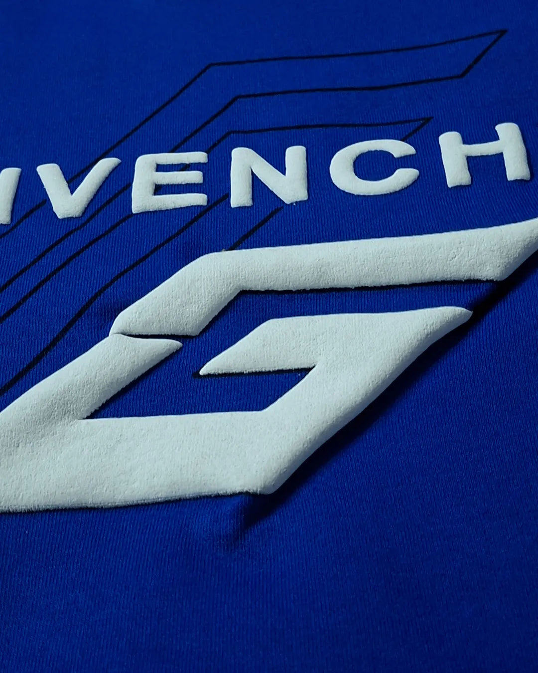 Close-up of Givenchy logo on a blue background