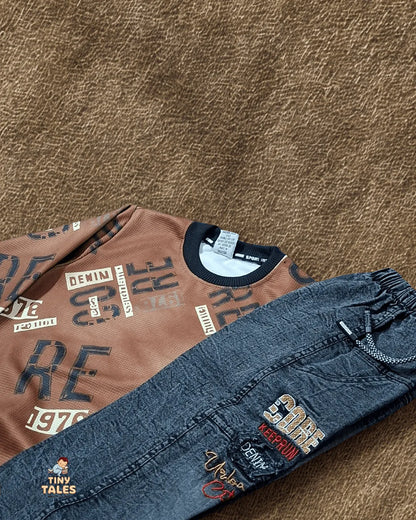 Brown shirt with text and blue jeans with patches on a brown textured surface