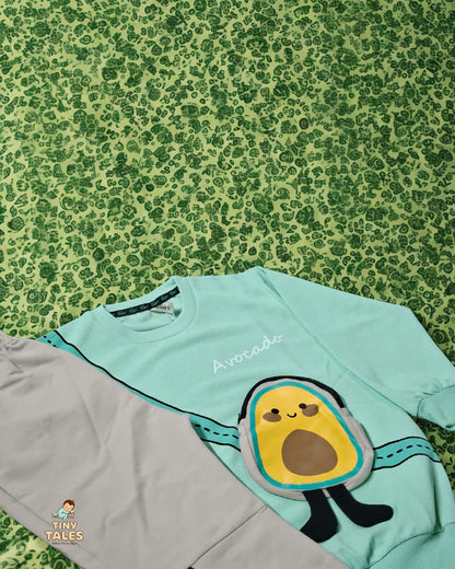 Light blue shirt with avocado design on a green patterned background