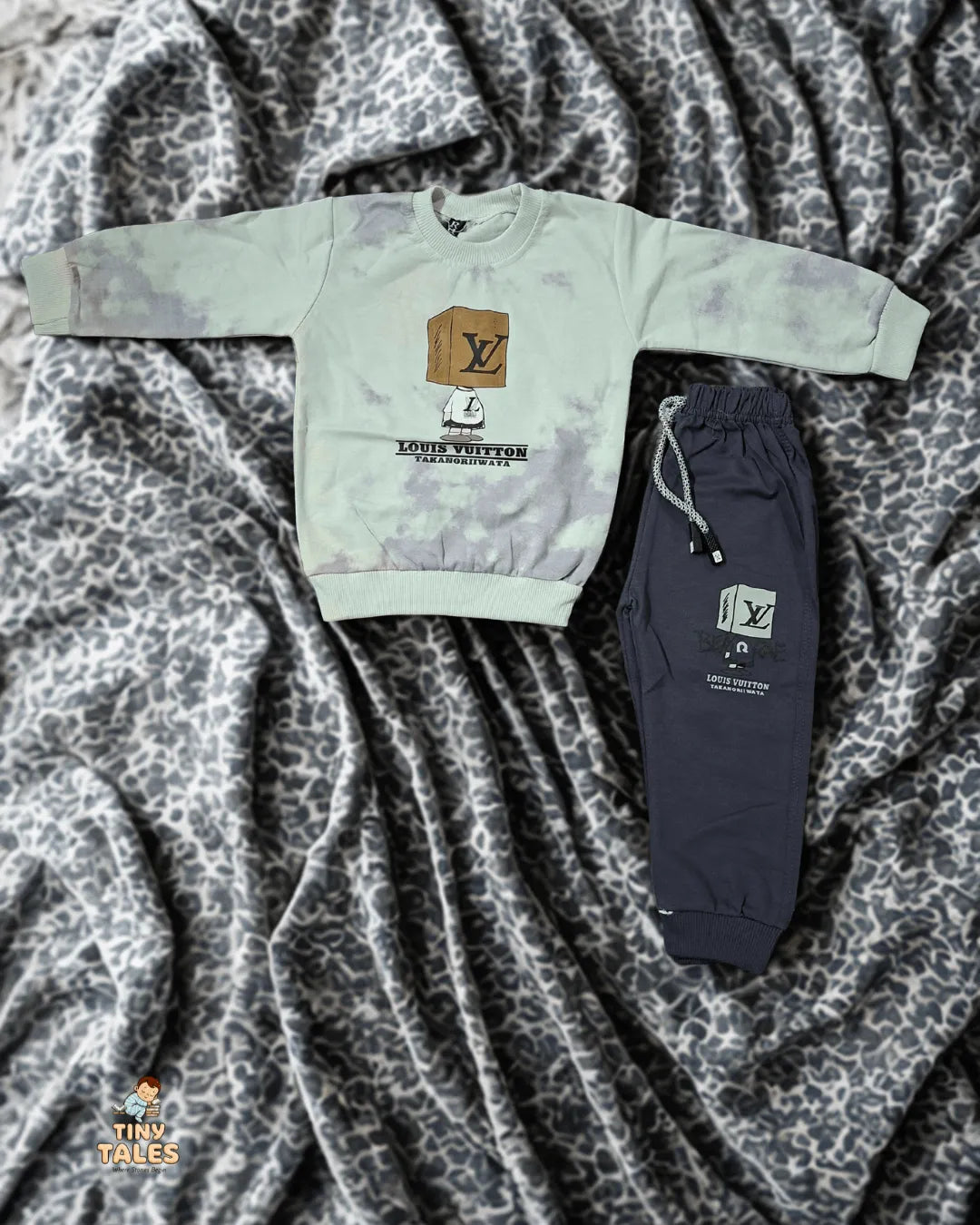 Louis Vuitton sweatshirt and jogger pants on a textured fabric background