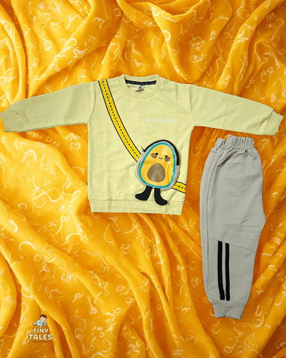 Children's sweatshirt with cartoon design and gray pants on a yellow fabric background